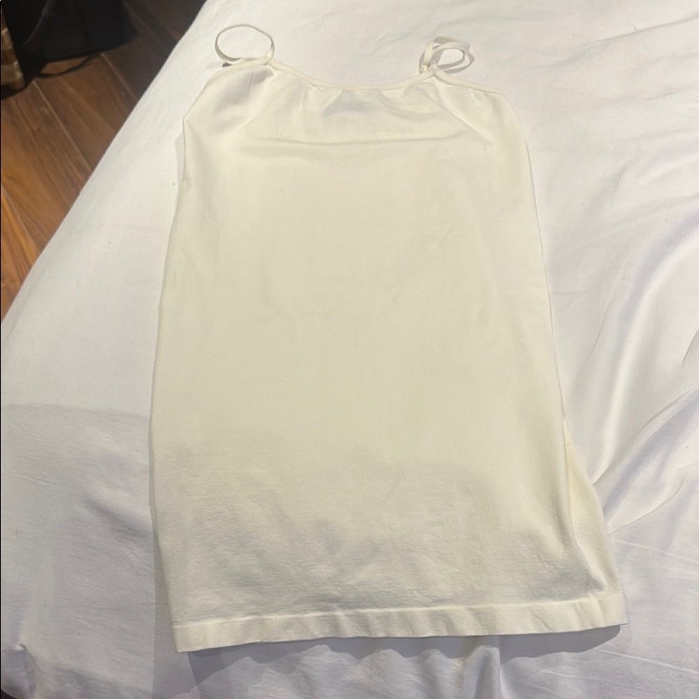 Beautiful stretchy off white colour adjustable tank top.